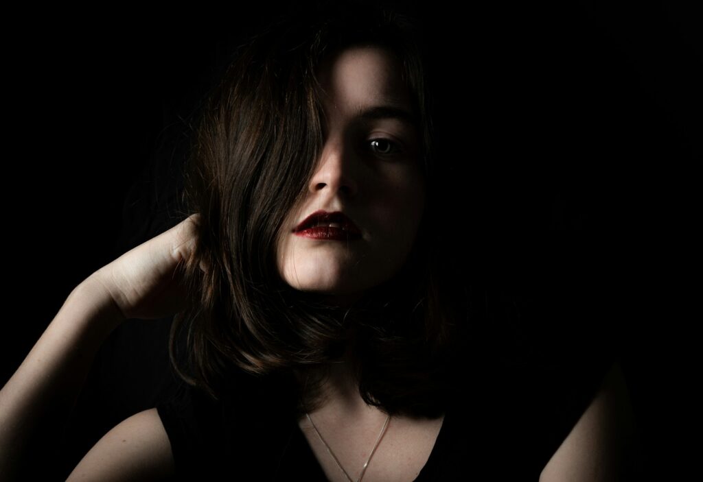 a woman in a black dress posing for a picture