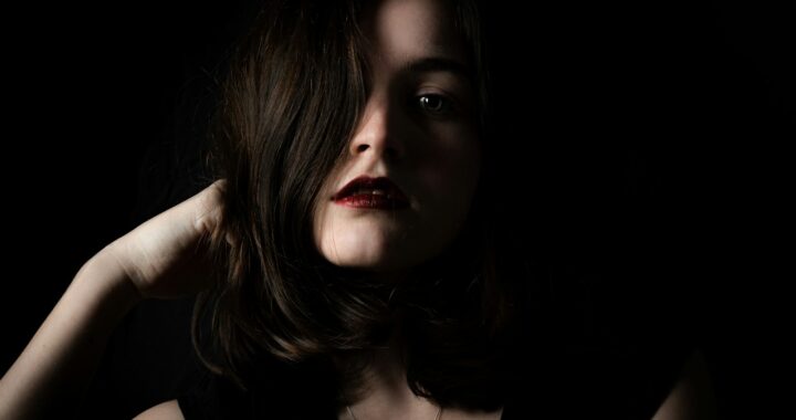 a woman in a black dress posing for a picture